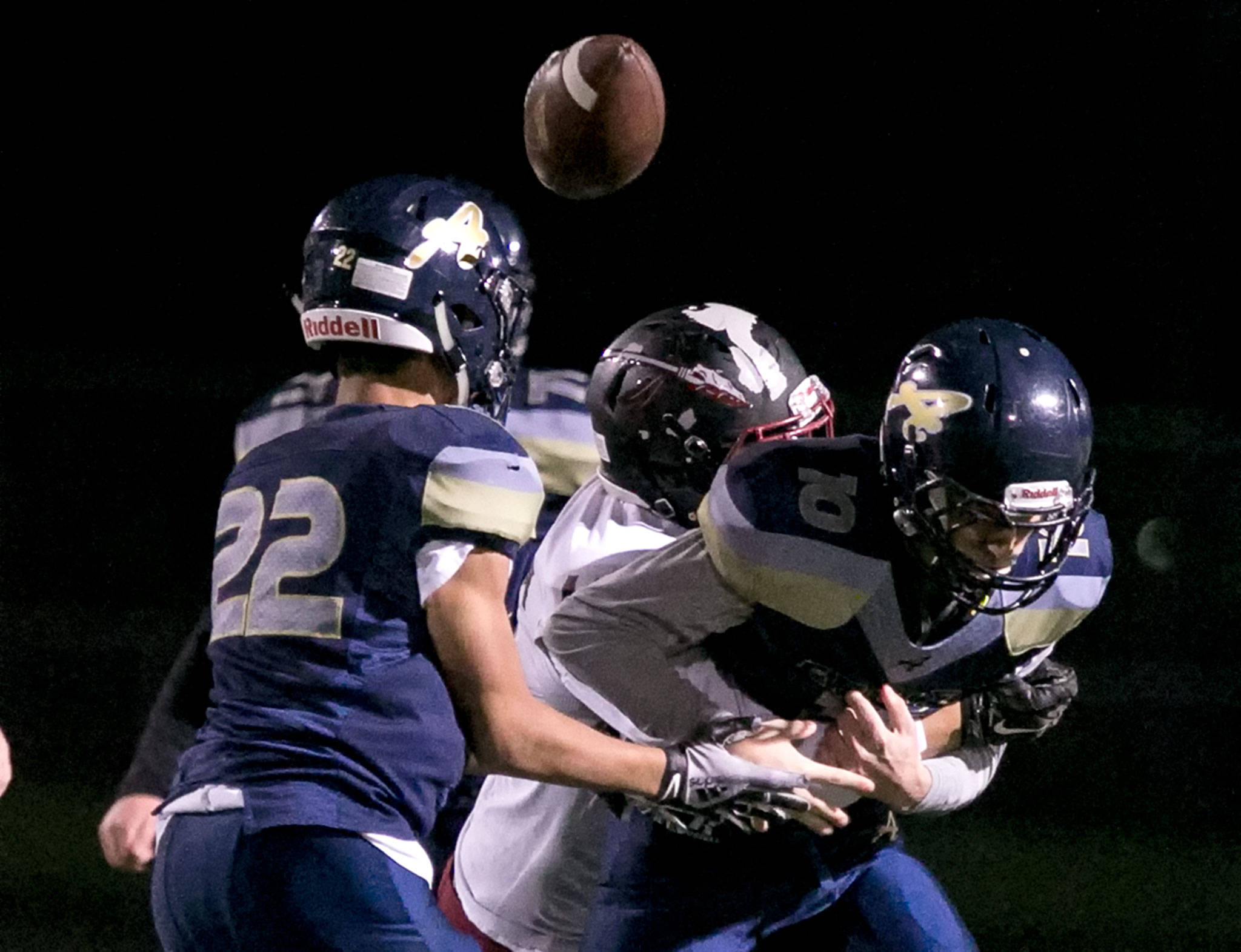 Bethel’s Parker Wimer forces a fumble by Arlington quarterback Anthony Whitis with Brayden Whetstone (left) looking on during a Week 10 playoff game on Nov. 2, 2018, at Arlington High School. Bethel won 50-15. (Kevin Clark / The Herald)
