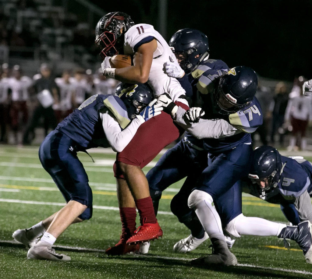 Bethel’s Will Latu (11) fights his way over the goal line for a touchdown during a Week 10 playoff game against Arlington on Nov. 2, 2018, at Arlington High School. Bethel won 50-15. (Kevin Clark / The Herald)
