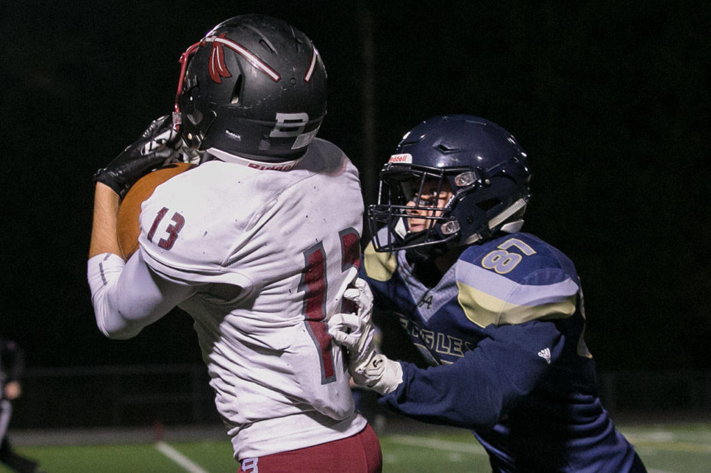Bethel’s Cameron Parker (13) catches a touchdown with Arlington’s Dylan Simmons defending during a Week 10 playoff game on Nov. 2, 2018, at Arlington High School. Bethel won 50-15. (Kevin Clark / The Herald)
