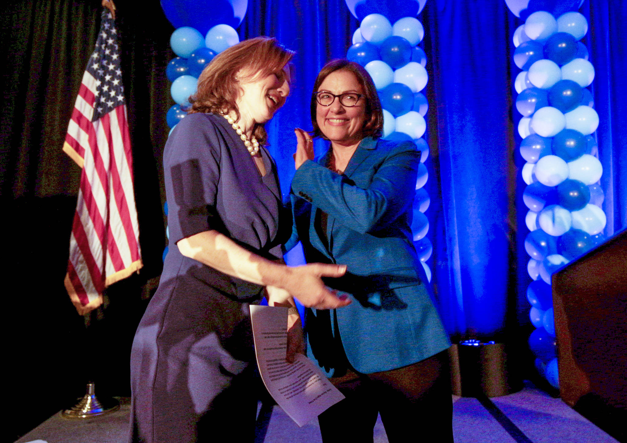 U.S. Rep. Suzan DelBene of Washington’s 1st District gave 8th District candidate Dr. Kim Schrier a hug after speaking at the Washington State Democratic Party’s 2018 election night party at the Bellevue Hilton on Tuesday. Schrier was leading GOP candidate Dino Rossi. DelBene handily won re-election. (Andy Bronson / The Herald)