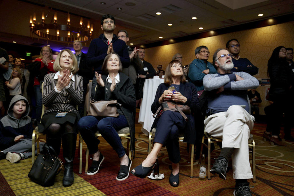 Watching a screen, Elaine Woo (left) and Laurie Cowan clap as returns come in at the Washington State Democratic Party’s 2018 Election Night Watch Party at the Bellevue Hilton on Tuesday. (Andy Bronson / The Herald)
Elaine Woo (left) and Laurie Cowan clap as returns come in at the Washington State Democratic Party’s election night party at the Bellevue Hilton on Tuesday. (Andy Bronson / The Herald) 
