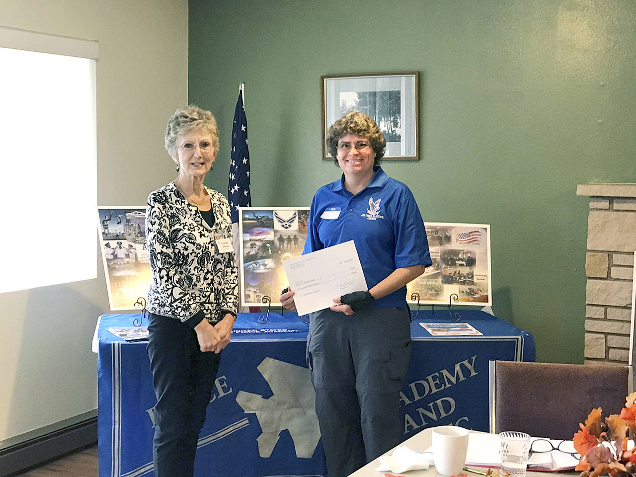 Camano Island Women’s Republican Club treasurer Linda Navarre presents retired Air Force Col. Tracy Merck with a $200 donation for Camano Chapel’s His Veterans Ministry. (Contributed photo)