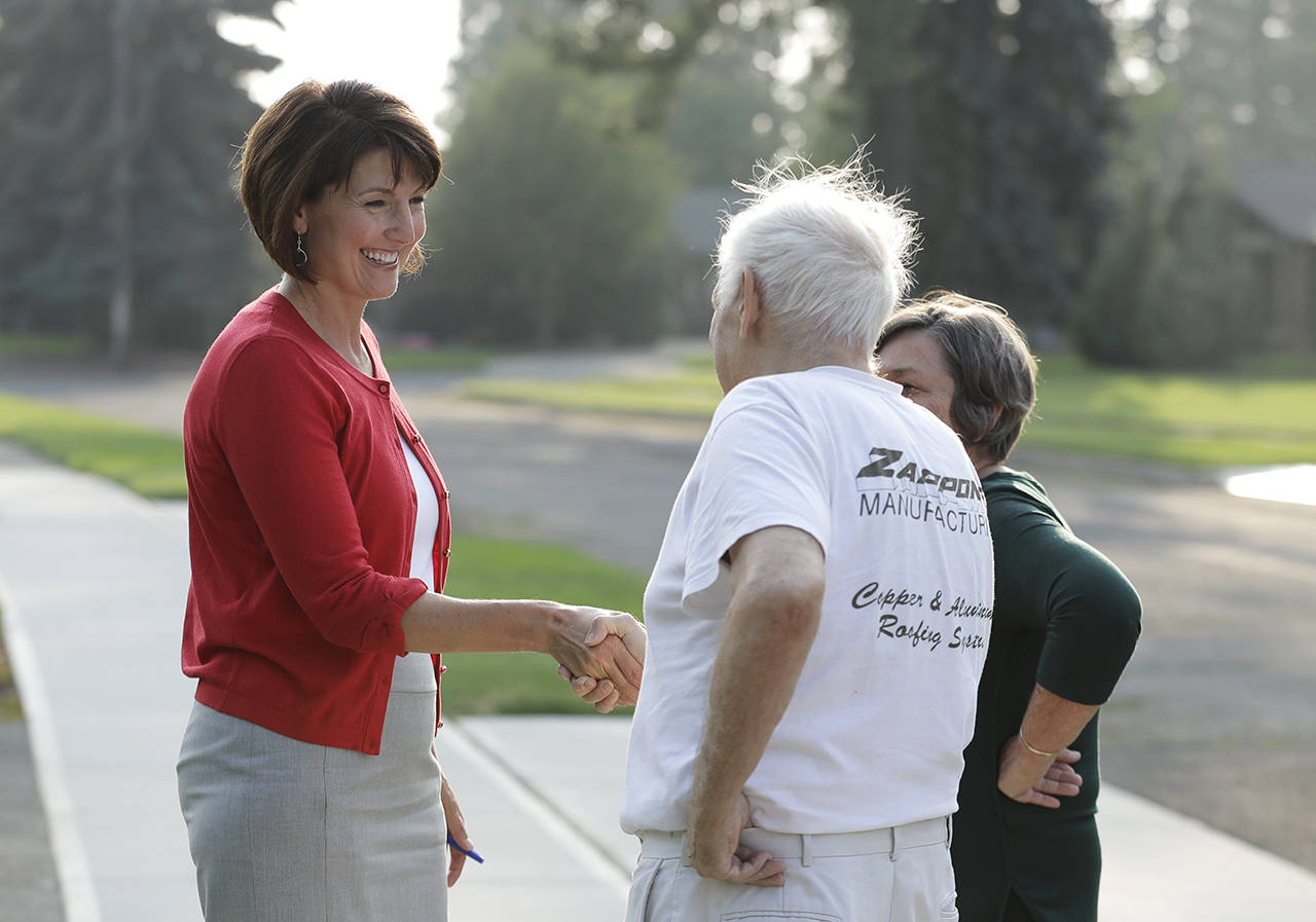 In this Aug. 22 photo, U.S. Rep. Cathy McMorris Rodgers shakes hands as she campaigns in Spokane. (AP Photo/Ted S. Warren, file)
