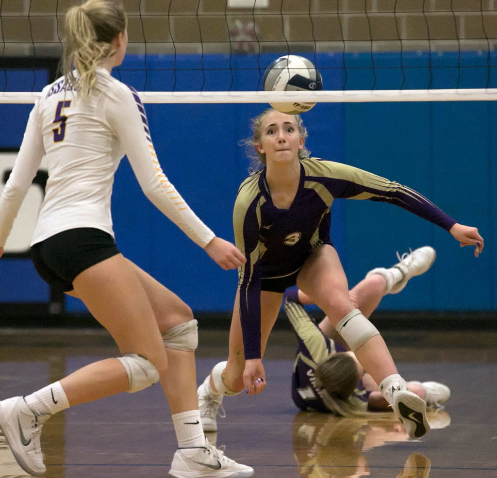 Lake Stevens’ Samaya Morin attempts a dig with Issaquah’s Zoe Hennings (left) looking on during the Wes-King 4A District Tournament on Nov. 6, 2018, at Bothell High School. (Kevin Clark / The Herald)

