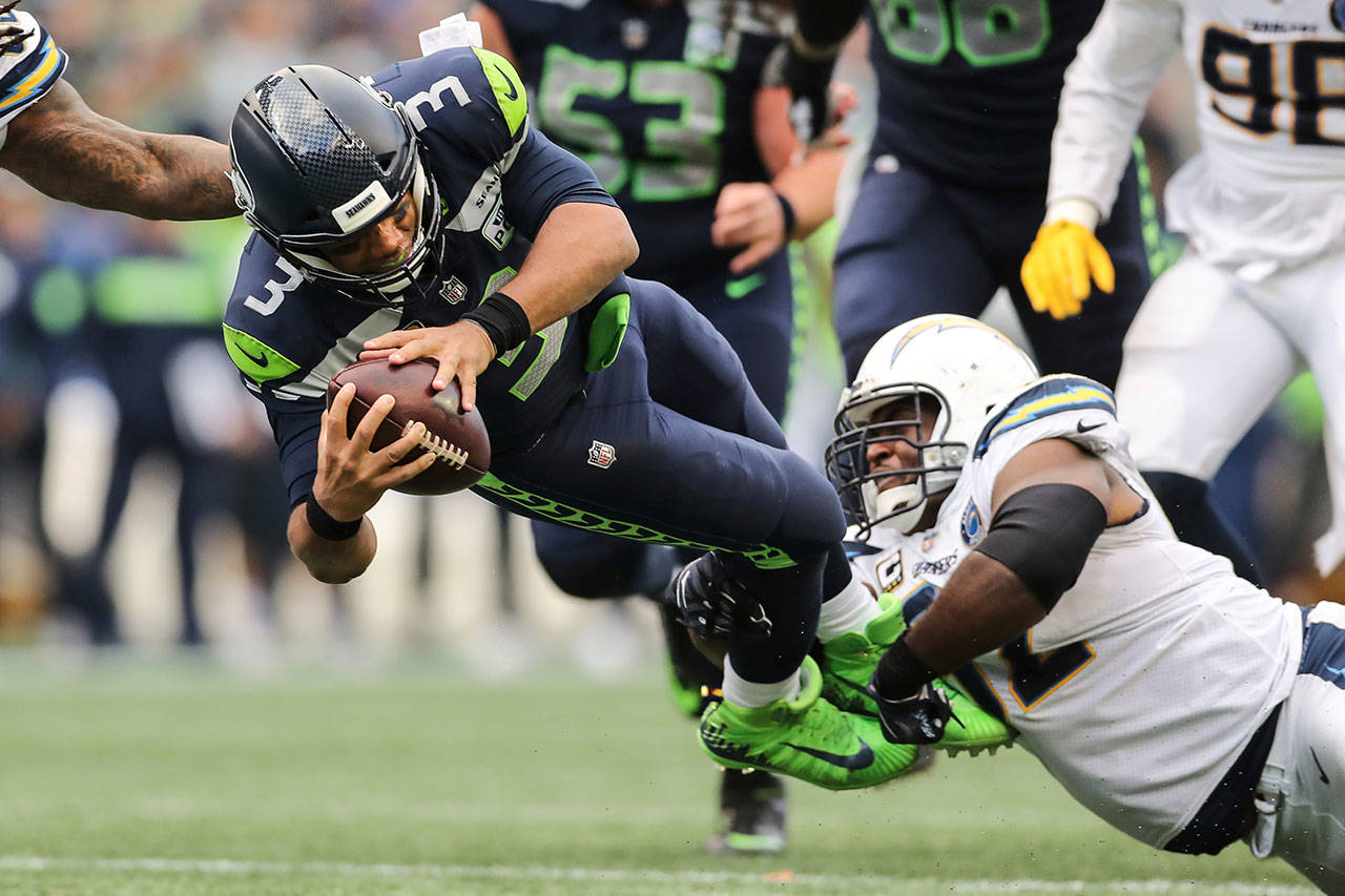 Seahawks quarterback Russell Wilson (3) dives for extra yardage in the second half of a game against the Chargers on Nov. 4, 2018, in Seattle. (AP Photo/Peter Joneleit)