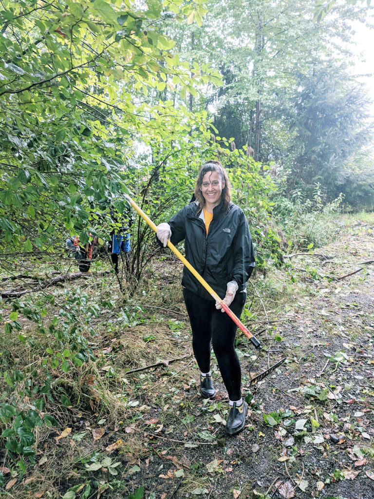 Jenie Jones, an Arlington Rotary member, participated in a rainy service project to restore a section of land along Portage Creek. (Contributed photo)

