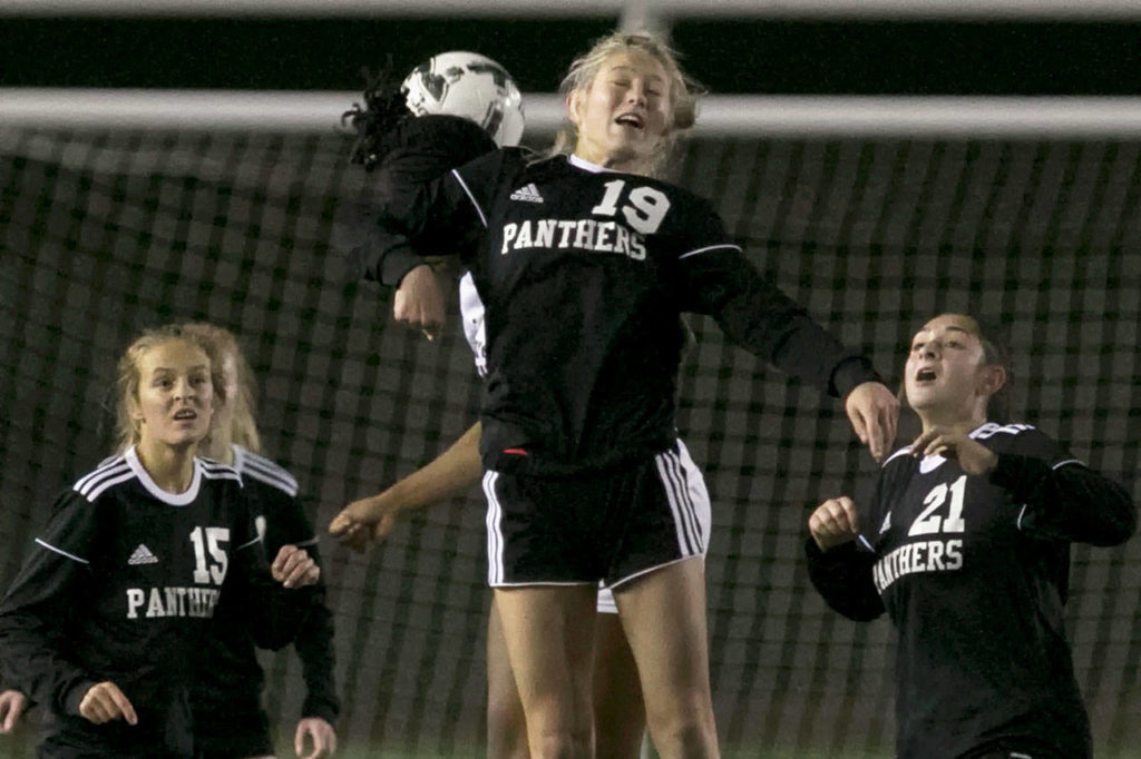 Snohomish&rsquo;s Gracie Winders jumps for a header during the Panthers&rsquo; 2-0 loss to Holy Names on Wednesday in a 3A State Tournament first-round match at Veterans Memorial Stadium in Snohomish. (Kevin Clark / The Herald)
