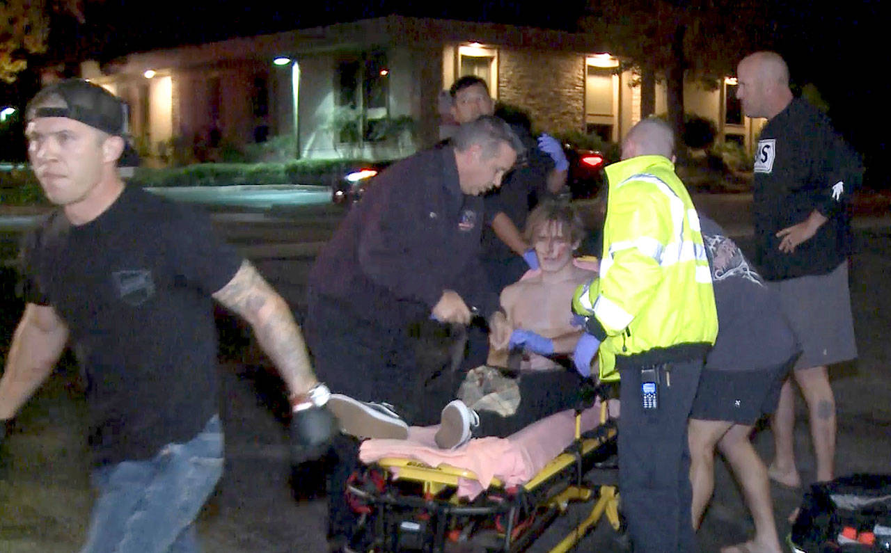 A victim is treated near the scene of a shooting Wednesday night in Thousand Oaks, California. (RMG News via AP)