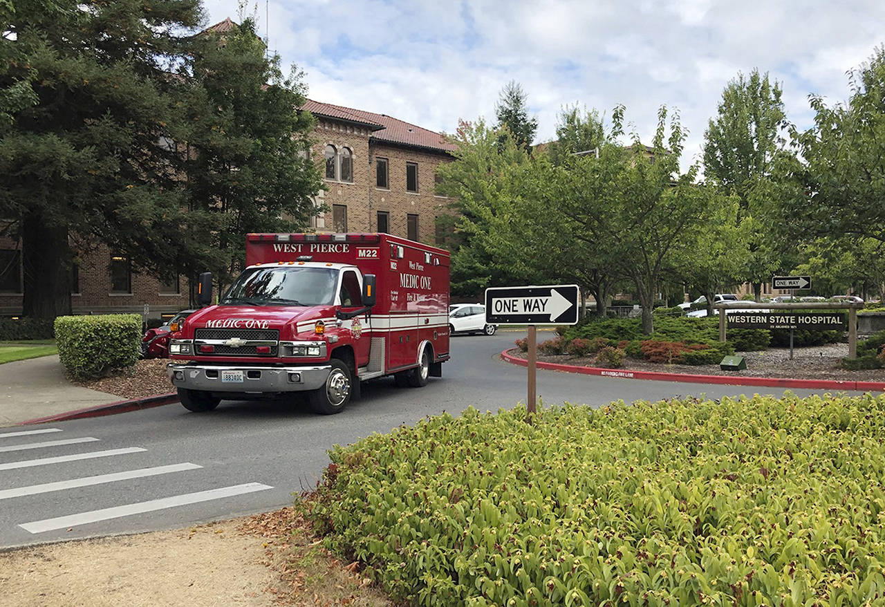In this Aug. 30 photo, an ambulance leaves Western State Hospital in Lakewood, Washington. (AP Photo/Martha Bellisle, File)