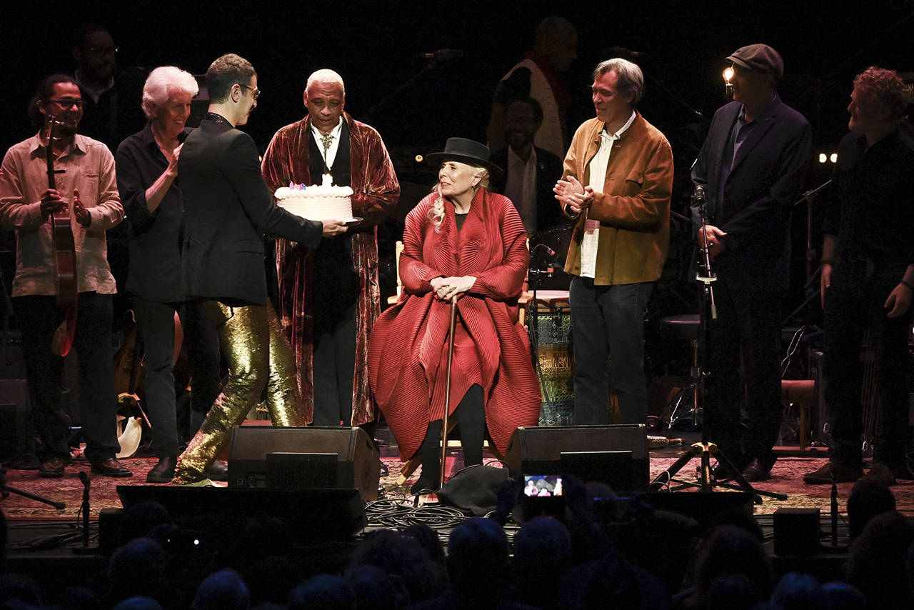 Joni Mitchell is presented with a birthday cake on stage at JONI 75: A Birthday Celebration on Nov. 7 at the Dorothy Chandler Pavilion in Los Angeles. (Photo by Richard Shotwell/Invision/AP)