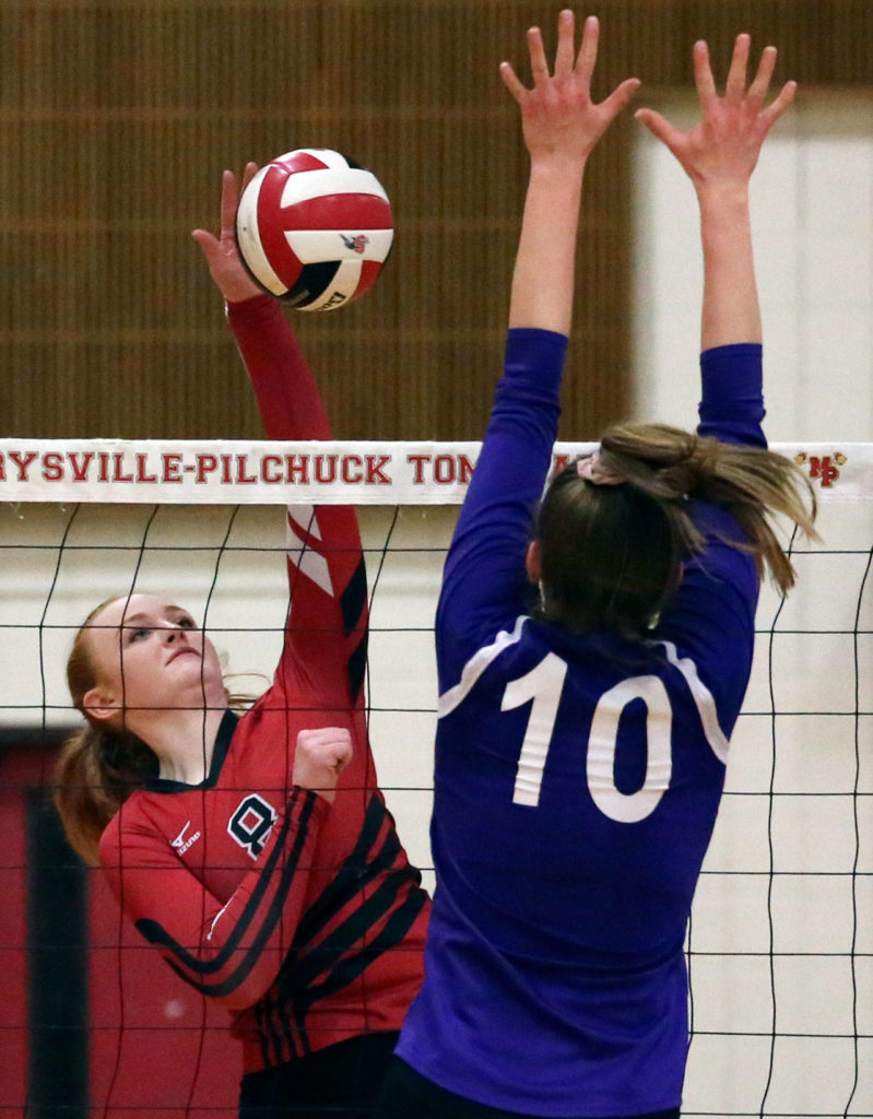 Snohomish’s Grace Raper (left) spikes over Oak Harbor’s Morgan Pease during a 3A Northwest District tournament match Thursday at Marysville Pilchuck High School. (Kevin Clark / The Herald)
