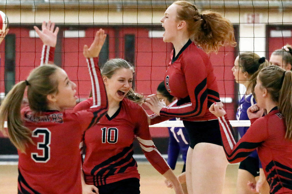 Snohomish celebrates a point Thursday night at Marysville Pilchuck High School. Snohomish won in straight sets. (Kevin Clark / The Herald)
