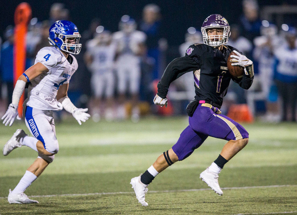 Lake Stevens’ Ian Hanson runs for a touchdown during a 4A state playoff game against Curtis on Nov. 9 in Lake Stevens. (Olivia Vanni / The Herald)
