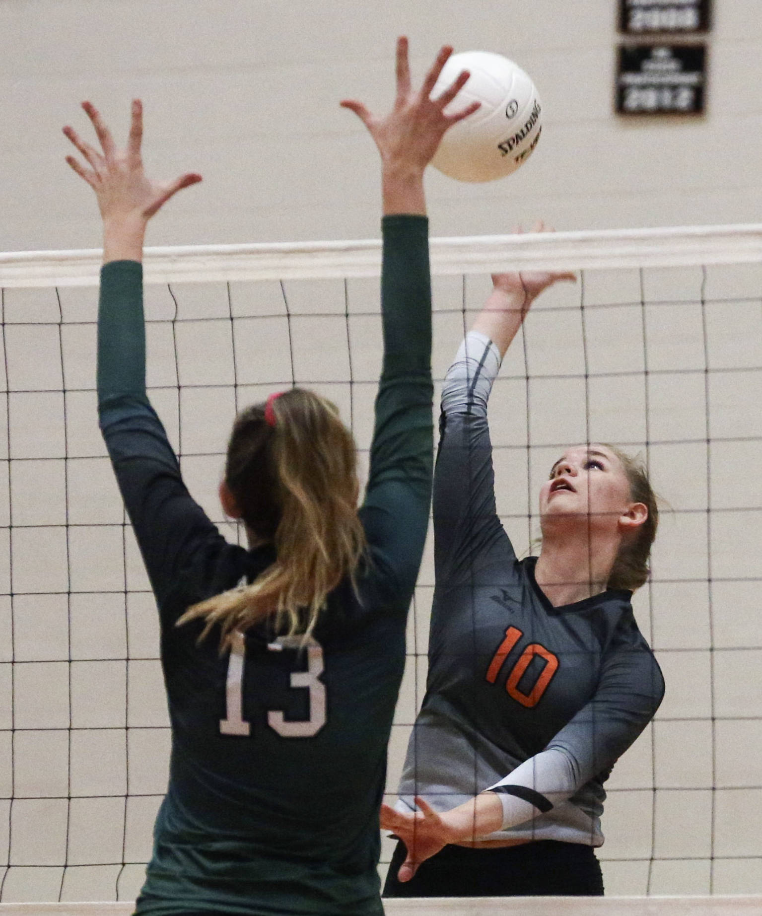 Kevin Clark / The Herald                                Monroe’s Tatum McGovern (right) attempts a kill over Jackson’s Ainsley Johanson during a match on Oct. 9 at Monroe High School.