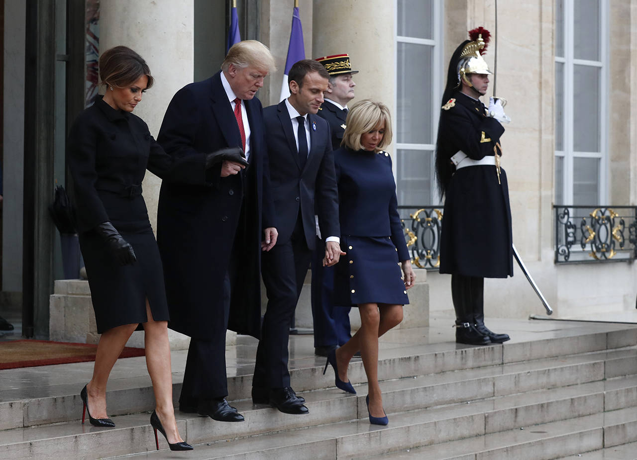 French President Emmanuel Macron (second right), his wife, Brigitte, U.S. President Donald Trump, and first lady Melania Trump (left) leave the Elysee Palace in Paris on Saturday. Trump is joining other world leaders at centennial commemorations in Paris this weekend to mark the end of World War I. (AP Photo/Thibault Camus)