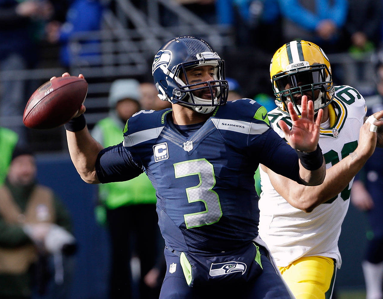 Seahawks quarterback Russell Wilson drops back to pass during the first half of the NFC Championship game against the Packers on Jan. 18, 2015, in Seattle. (AP Photo/David J. Phillip)