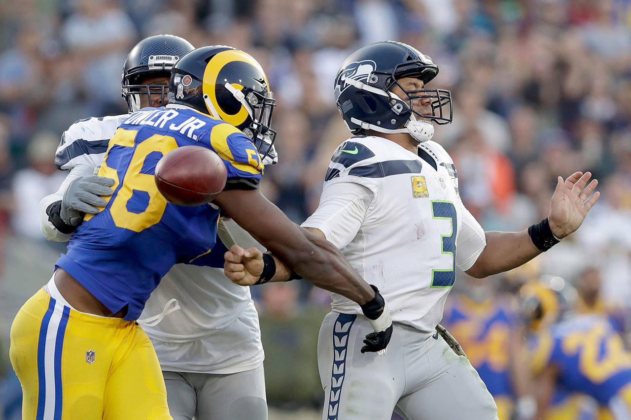 Alex Gallardo / Assocaited Press                                Los Angeles Rams defensive end Dante Fowler forces a fumble by Seattle Seahawks quarterback Russell Wilson in the fourth quarter of Sunday’s game in in Los Angeles.