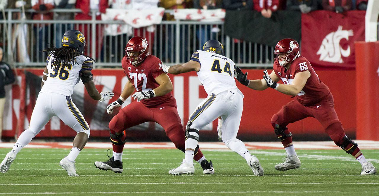 Abe Lucas (72) and Josh Watson (65) are starters on the right side of the Washington State Cougars’ offensive line.