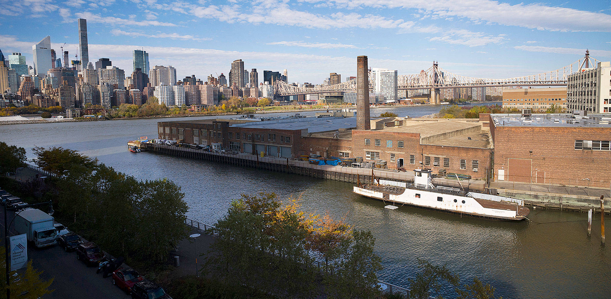 A rusting ferryboat is docked next to an aging industrial warehouse on Long Island City’s Anable Basin in the Queens borough of New York. (AP Photo/Mark Lennihan)