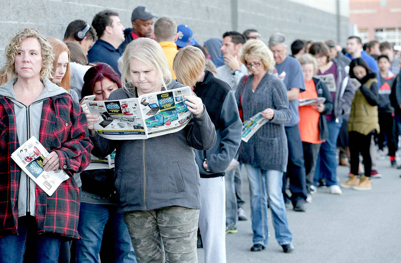 People wait in line in 2017 for a Best Buy store to open for a Black Friday sale on Thanksgiving Day, in Overland Park, Kansas. (Associated Press file photo / Charlie Riedel)