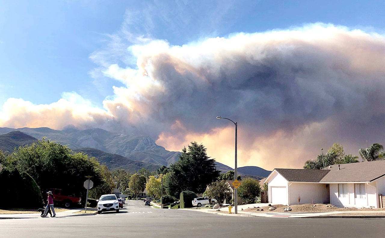 A large wildfire plume from a recent flareup near Lake Sherwood, California, is visible from Thousand Oaks on Tuesday. (Associated Press / Amanda Myers)