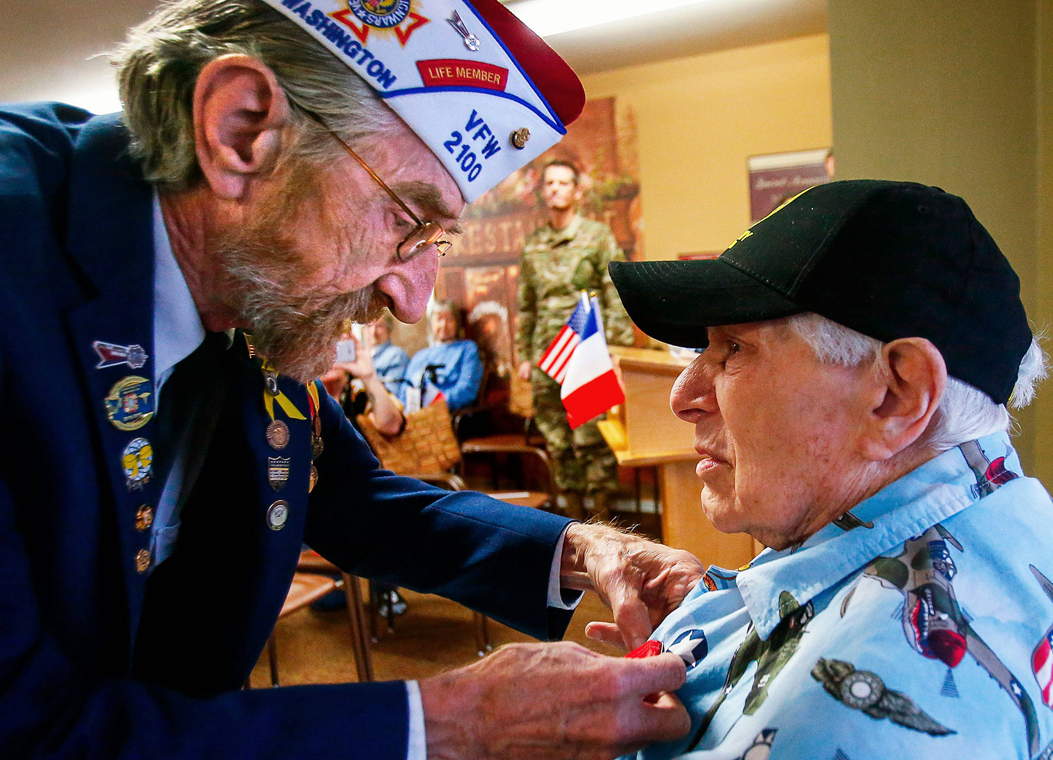 For his contribution to Allied efforts to liberate France during WW II, Peter Bellecy, 96, receives the French Legion of Honor medal Nov. 14. Presenting the medal and pinning it to Bellecy’s shirt is Donald Wischmann, quartermaster of Veterans of Foreign Wars Post 2100 in Everett. (Dan Bates / The Herald)