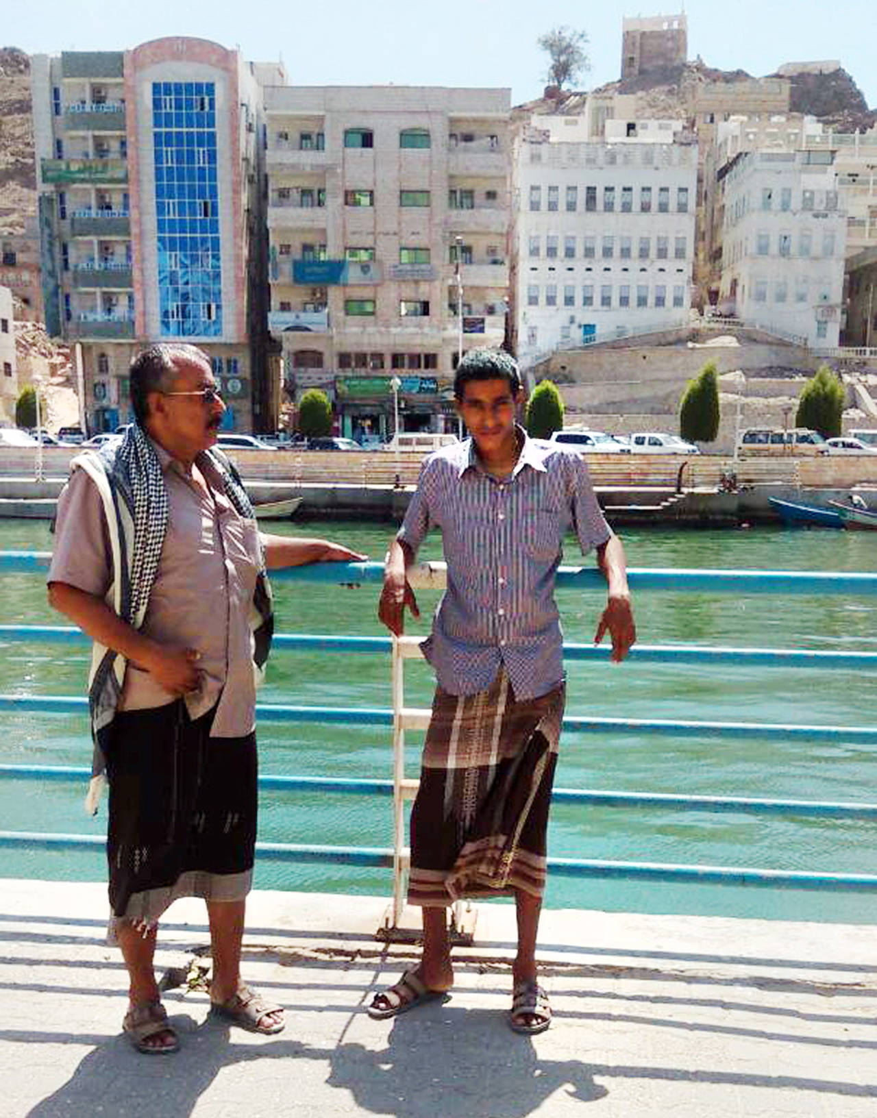 Abdullah Saleh Elwiya (right) and his father, Saleh Elwiya, visited the coastal city of Mukalla in southern Yemen, months before he was lured away by al-Qaida. (Saleh family via AP)
