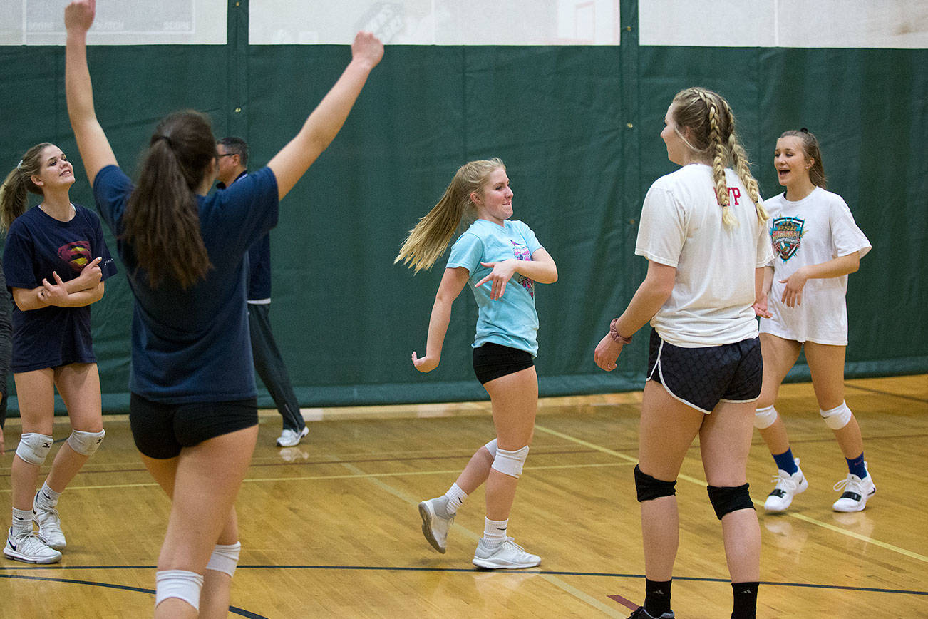 Meagan Tumy, center, spins after scoring point as her teammates celebrate as the Monroe Volleyball team practices in the gym at Hidden River Middle School on Tuesday, Nov. 13, 2018 in Snohomish, Wa. (Andy Bronson / The Herald)