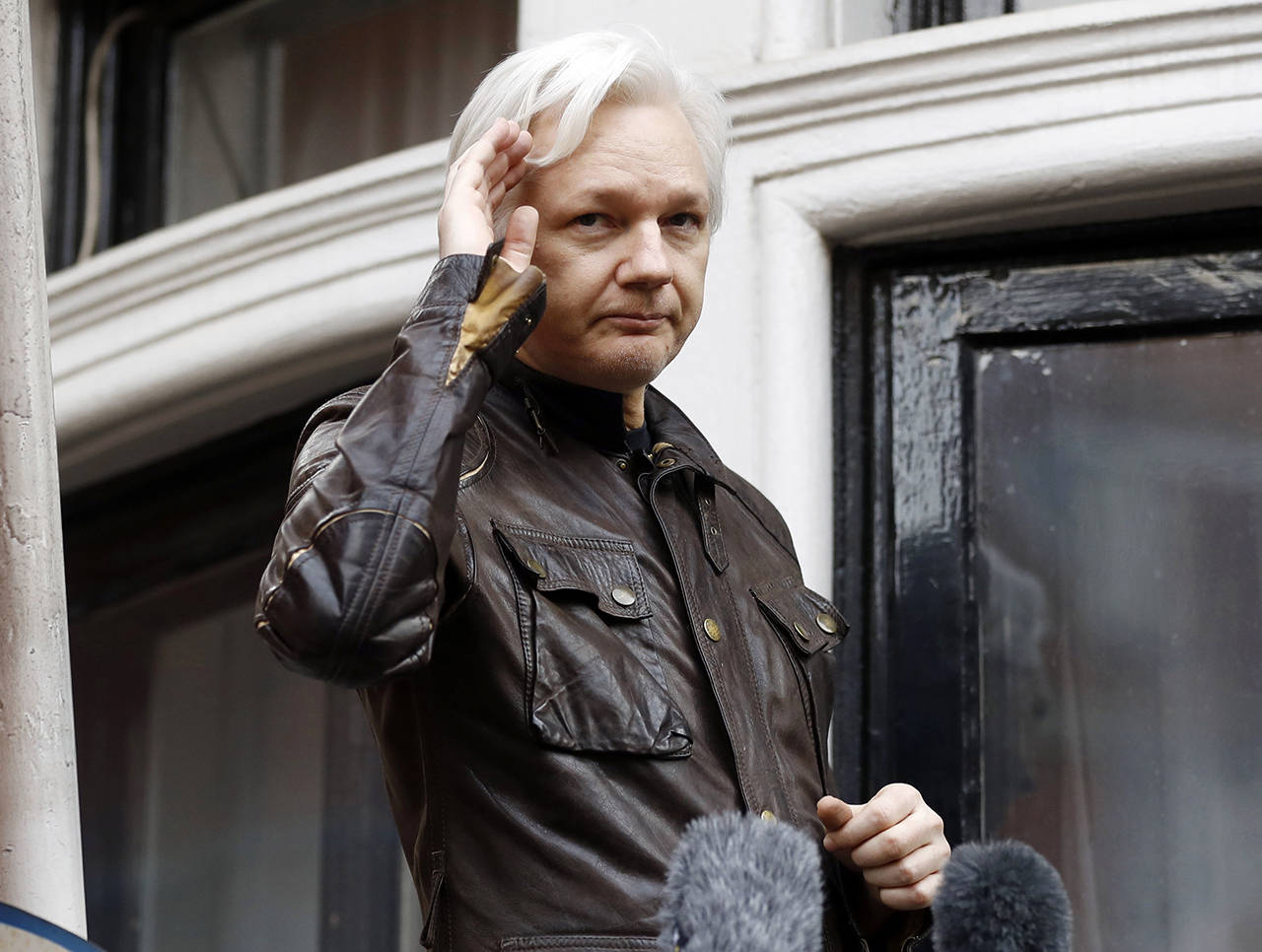 In this 2017 photo, WikiLeaks founder Julian Assange greets supporters from a balcony of the Ecuadorian embassy in London. (AP Photo/Frank Augstein, File)