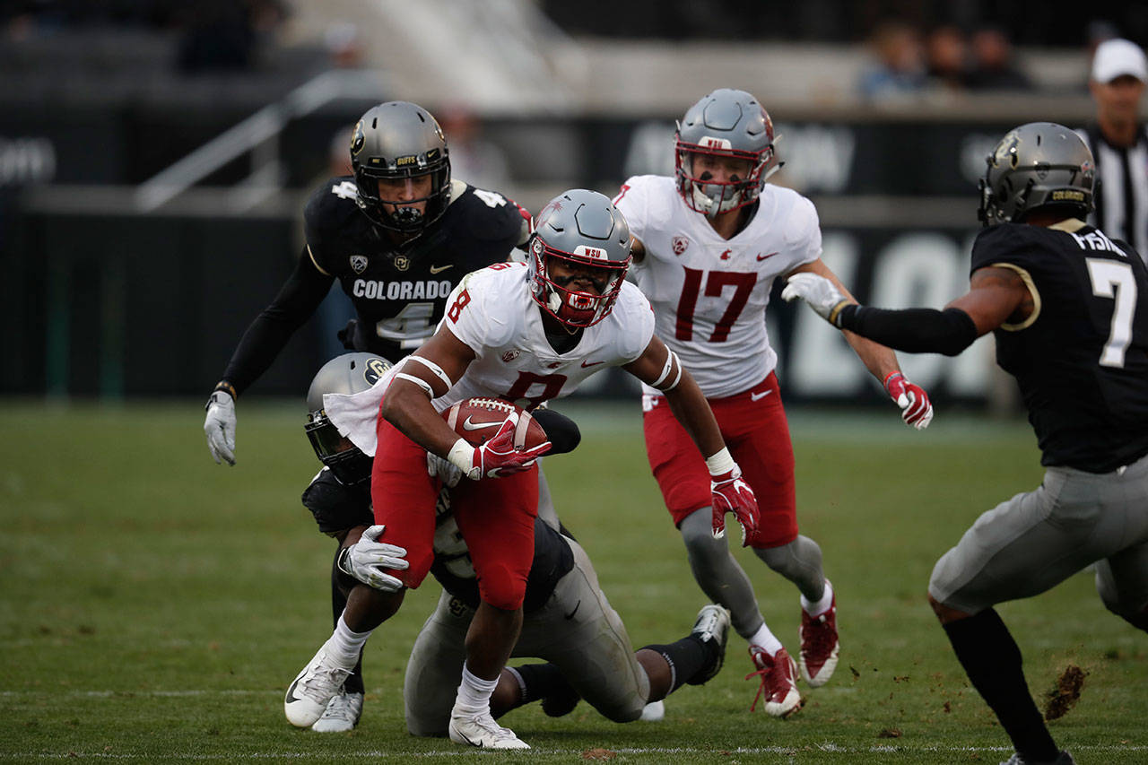 Washington State wide receiver Easop Winston Jr. (8) tires to shake loose a Colordao defender during the second half of a game on Nov. 10, 2018, in Boulder, Colo. (AP Photo/David Zalubowski)