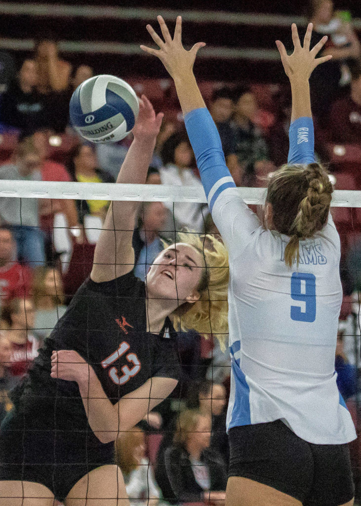 Monroe’s Samantha Zimmerman (13) spikes a ball past West Valley’s (Yakima) Kristah Tiffany (9) during a 4A state semifinal match on Nov. 17, 2018, at the Yakima Valley SunDome in Yakima. (TJ Mullinax / For The Herald)
