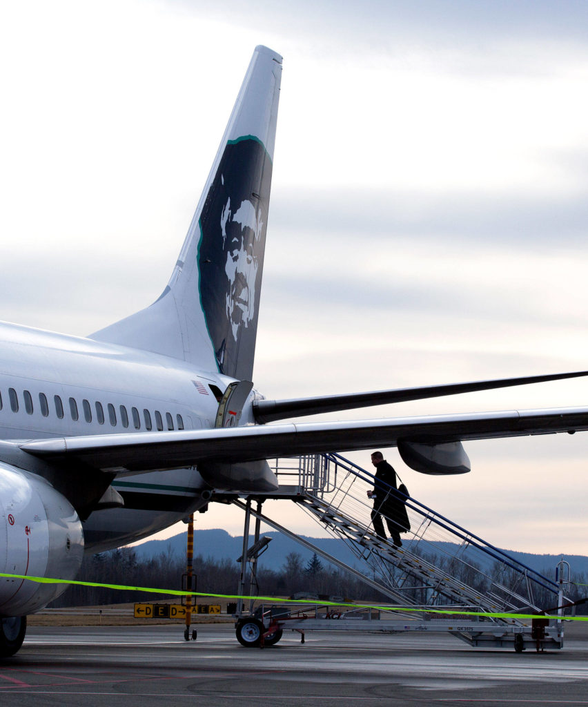 Passengers board to the rear of a jet at Bellingham International Airport on Jan. 26, 2017, in Bellingham. Alaska Airlines flies yearound to Seattle and Portland, and seasonally to Kona and Maui, Hawaii. With commercial flights set to start in Everett next year, Bellingham officials want to lure more customers with added destinations such as Mexico. (Andy Bronson / The Herald)
