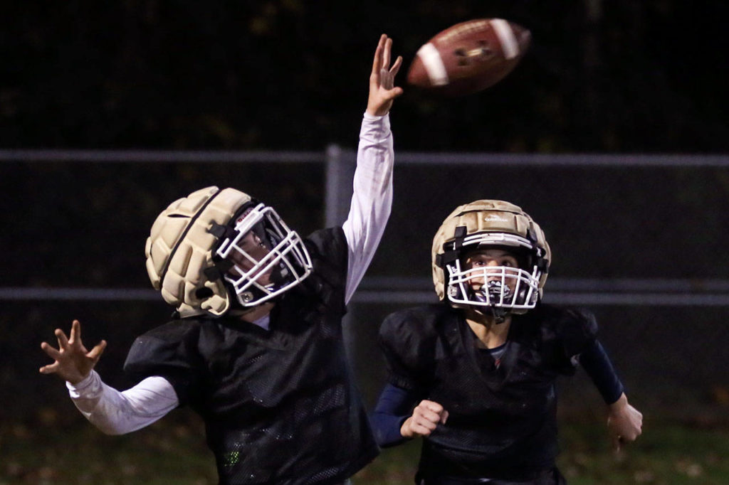 Connor Geary of the U14 Lake Stevens Vikings attempts to make a catch with Kaiden Duong (right) trailing during the team’s practice Thursday at the Lake Stevens Boys Girls Club. (Kevin Clark / The Herald)

