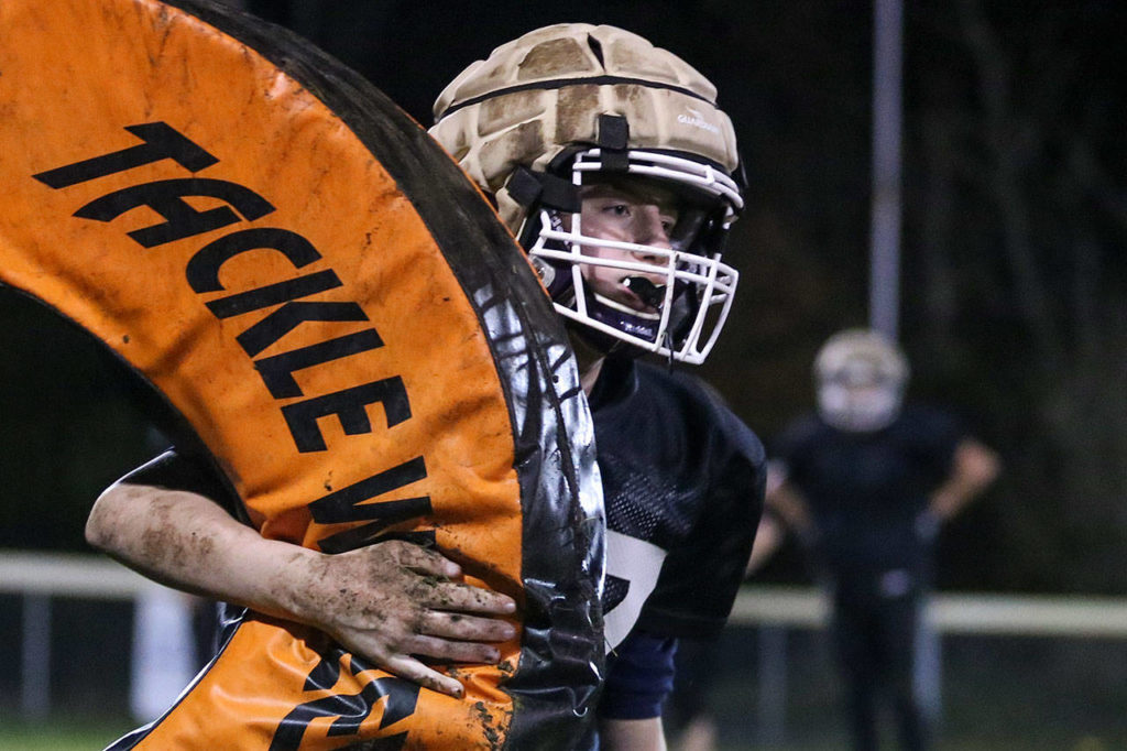 Connor Ewing of the U14 Lake Stevens Vikings returns a tackle wheel during a team practice Thursday at the Lake Stevens Boys Girls Club. (Kevin Clark / The Herald)

