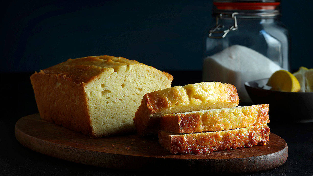 Lemon juice melted into granulated sugar forms a thin, shiny syrup that soaks into the loaf, bolstering its potency and imparting a glamorous gloss. (E. Jason Wambsgans/Chicago Tribune)