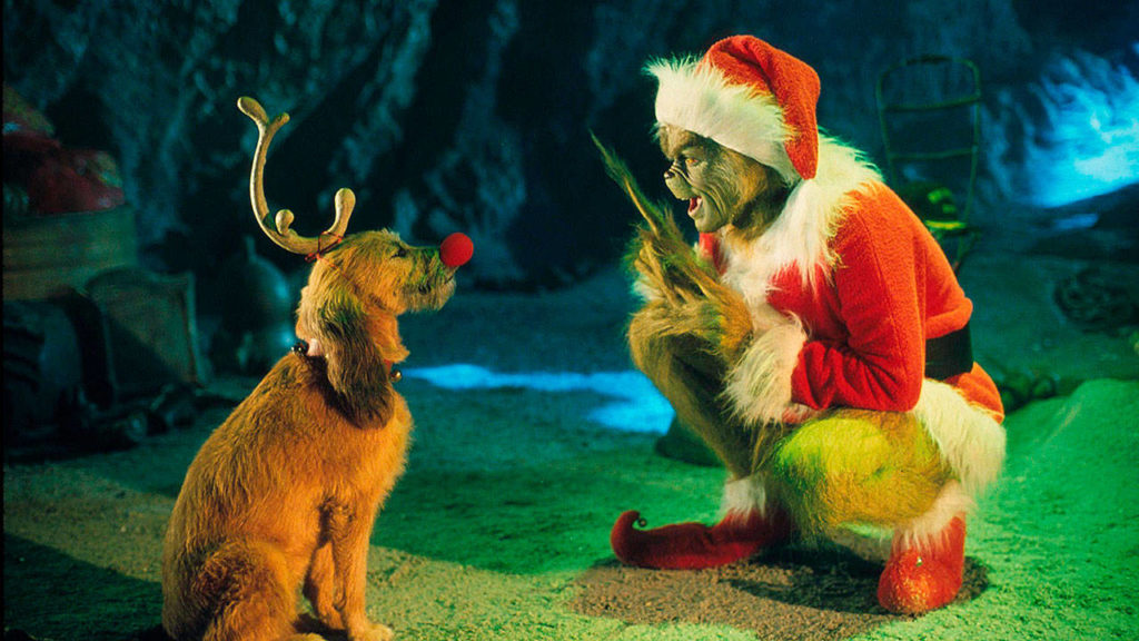 The Grinch, played by Jim Carrey, conspires with his dog Max to deprive the Whos of their favorite holiday in the 2000 live-action adaptation of “Dr. Seuss’ How The Grinch Stole Christmas.” (Universal Pictures)
