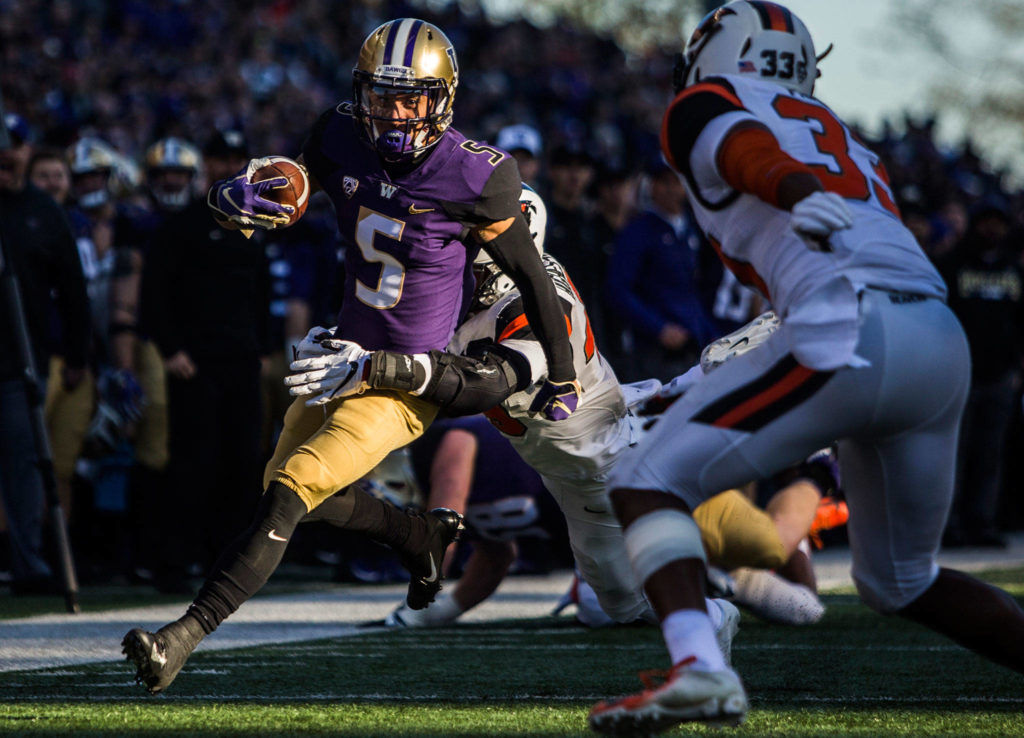 Washington’s Andre Baccellia runs through a tackle during the game against Oregon State on Saturday, Nov. 17, 2018 in Seattle, Wa. (Olivia Vanni / The Herald)
