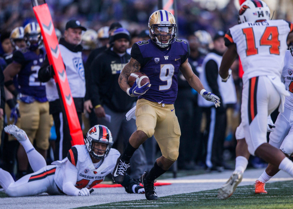 Washington’s Myles Gaskin escapes a tackle during the game against Oregon State on Saturday, Nov. 17, 2018 in Seattle, Wa. (Olivia Vanni / The Herald)
