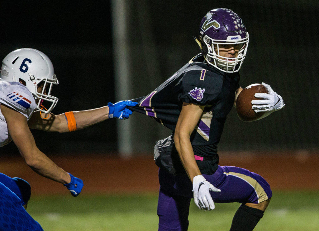 Lake Stevens’ Ian Hanson runs the ball into the end zone while his jersey is pulled during the game against Graham Kapowsin on Saturday, Nov. 17, 2018 in Lake Stevens, Wa. (Olivia Vanni / The Herald)
