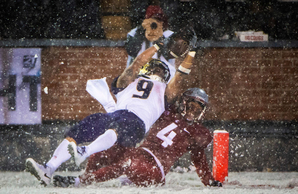 Washington running back Myles Gaskin (9) dives into the end zone as he’s tackled by Washington State’s Marcus Strong during the third quarter of the Apple Cup on Friday in Pullman. (Joshua Bessex/The News Tribune via AP)
