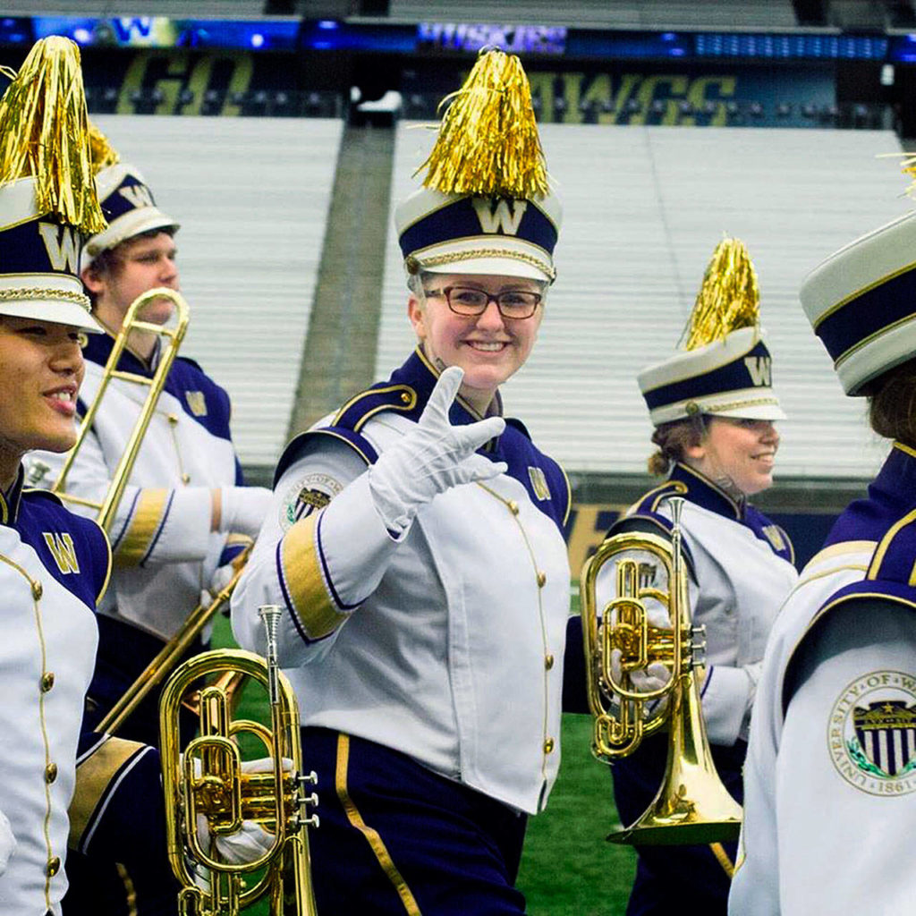Elizabeth Stanton, a 19-year-old UW sophomore from Lake Stevens, puts her “dubs up” as she carries her mellophone with the Husky Marching Band. She and her brother, Patrick Stanton, will play with the band Friday at the Pac-12 Championship game in Santa Clara, California. Her horn was on the band bus that rolled over last week on the way to the Apple Cup. She and her brother were on different buses. (Courtesy Elizabeth Stanton)
