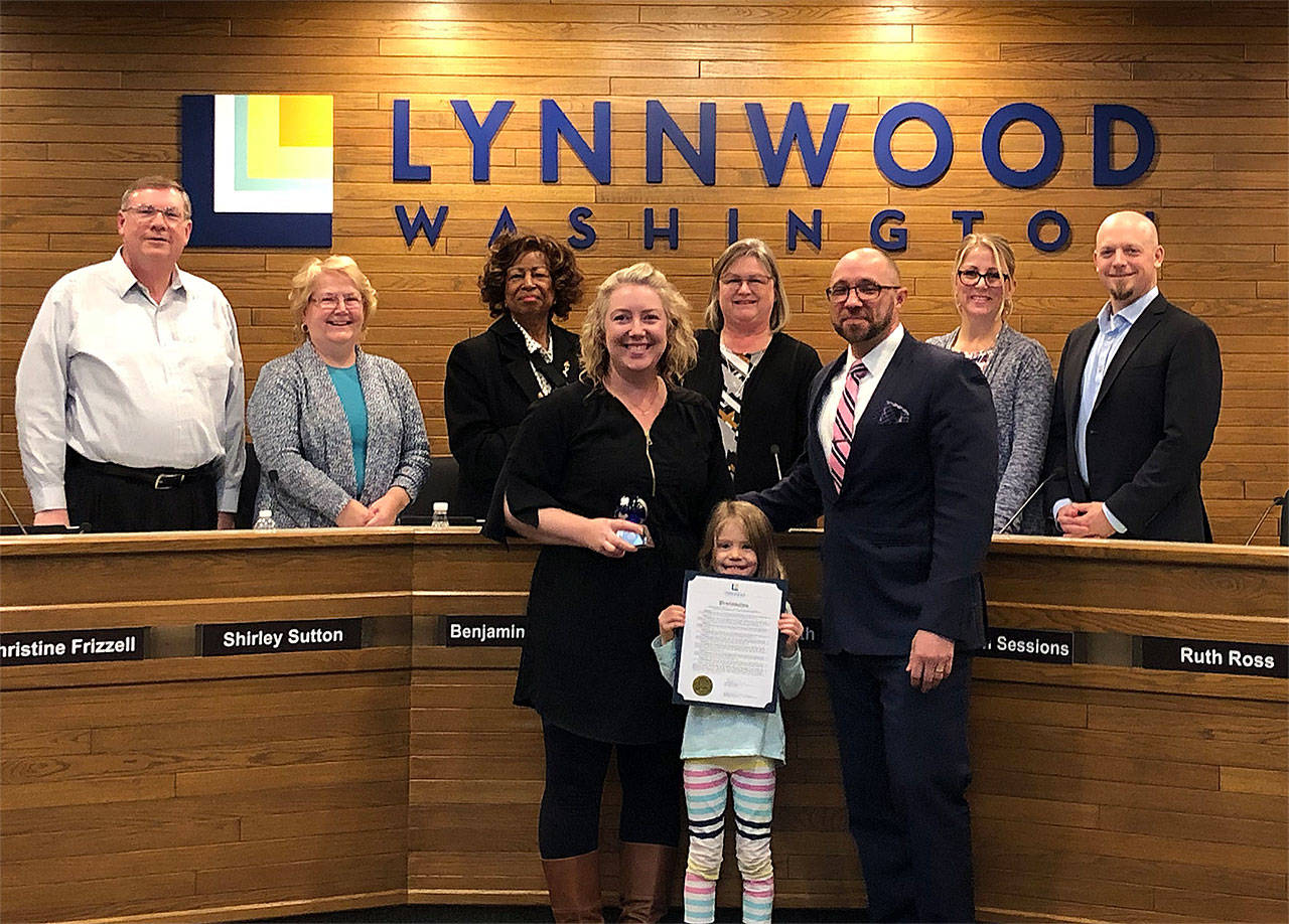 The city of Lynnwood on Nov. 13 presented its annual Excellence Awards. The Citizen Award was given to Monica Thompson, a landscape architect, pictured here with her daughter and City Council President Benjamin Goodwin. (Contributed photo)