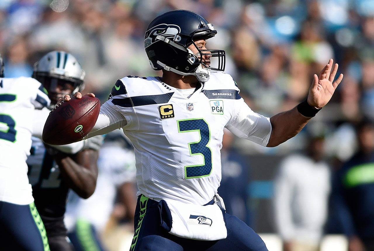 Seattle’s Russell Wilson looks to pass during the first half of the Seahawks’ 30-27 win over Carolina on Sunday in Charlotte, N.C. (AP Photo/Mike McCarn, File)