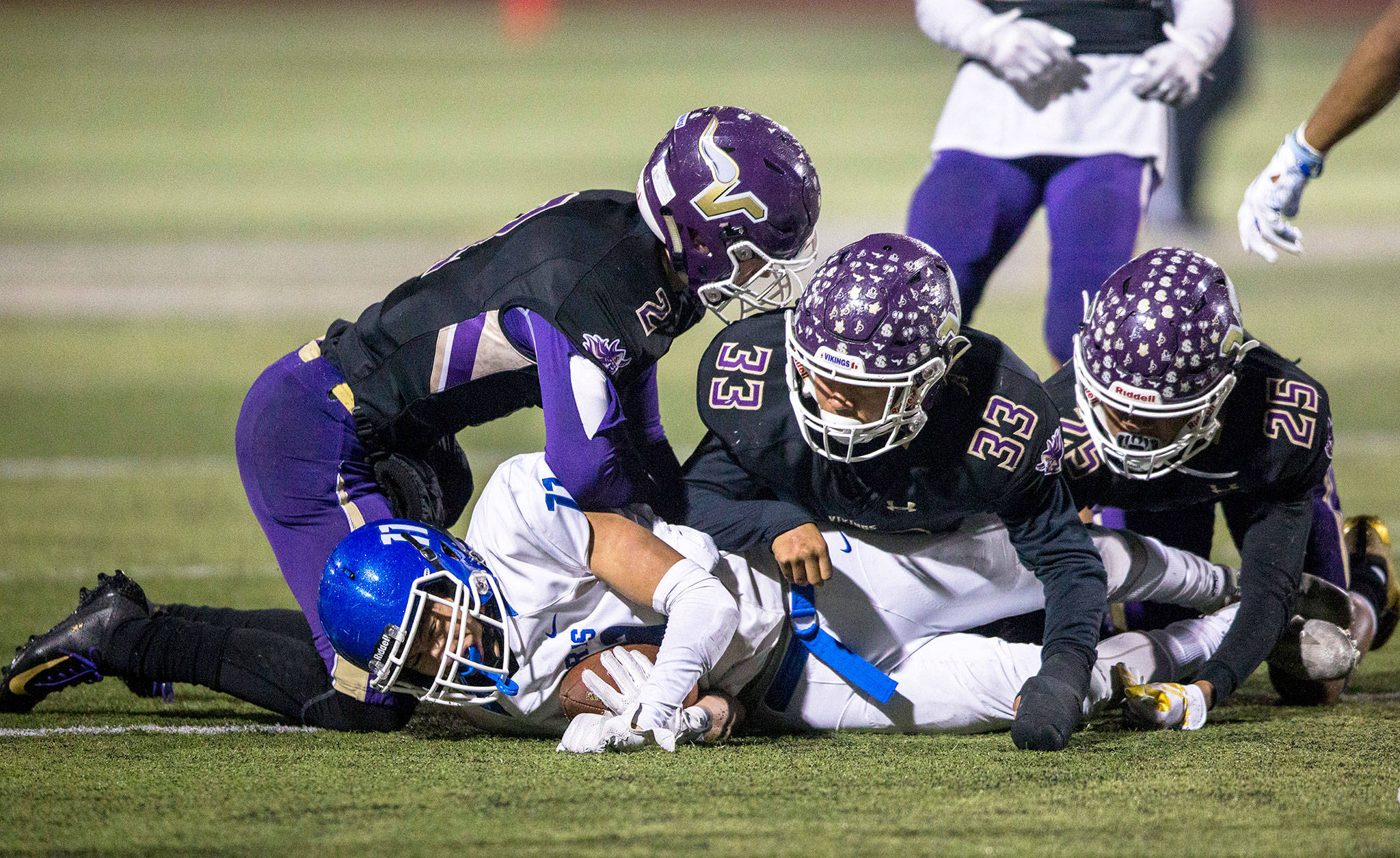 Lake Stevens’ Devin MacWatters (left), Junior Robinson (center) and Kasen Kinchen (right) tackle a Graham-Kapowsin player during the Nov. 9 game in Lake Stevens. (Olivia Vanni / The Herald)