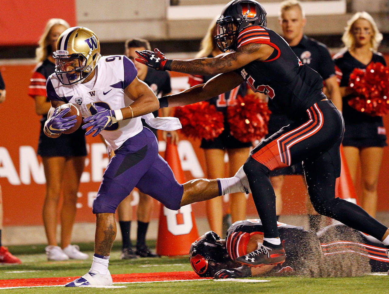Washington’s Myles Gaskin scores a touchdown in front of Utah’s Corrion Ballard during the first half of a Sept. 15 game in Salt Lake City. (AP Photo/Rick Bowmer, File)
