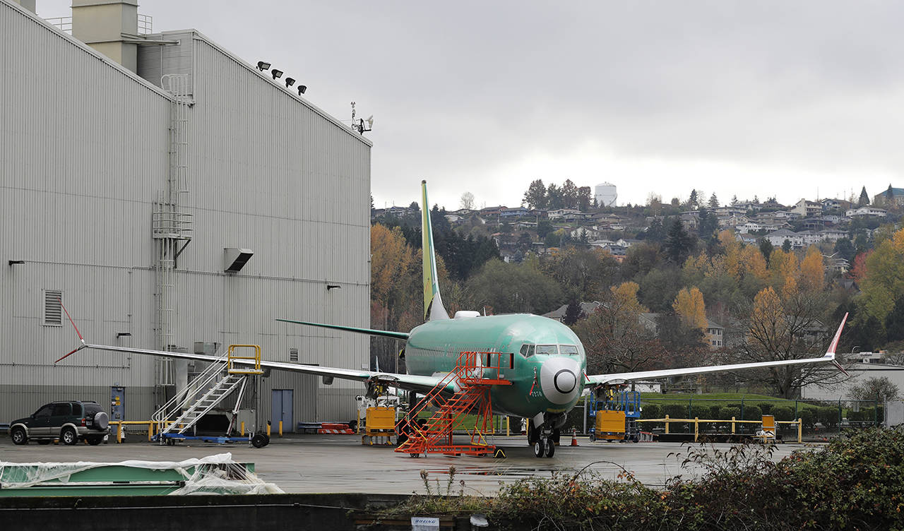 In this Nov. 14 photo, a Boeing 737 MAX 8 is parked outside Boeing Co.’s 737 assembly facility in Renton. (AP Photo/Ted S. Warren, File)