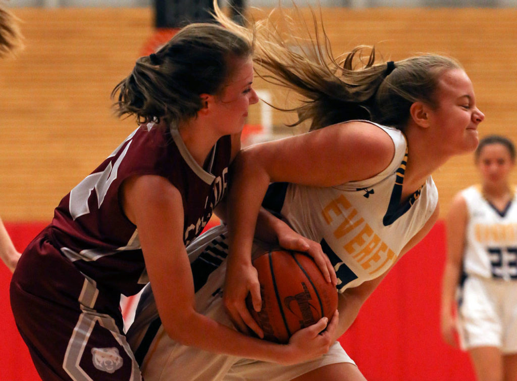 Everett’s Caroline Jameson (right) gets tied up with a Cascade defender for a jump ball during the annual BruGull Fest rivalry game Friday at the Walt Price Student Fitness Center at Everett Community College. Jameson and the Seagulls beat their cross-town rivals 51-13. (Kevin Clark / The Herald)
