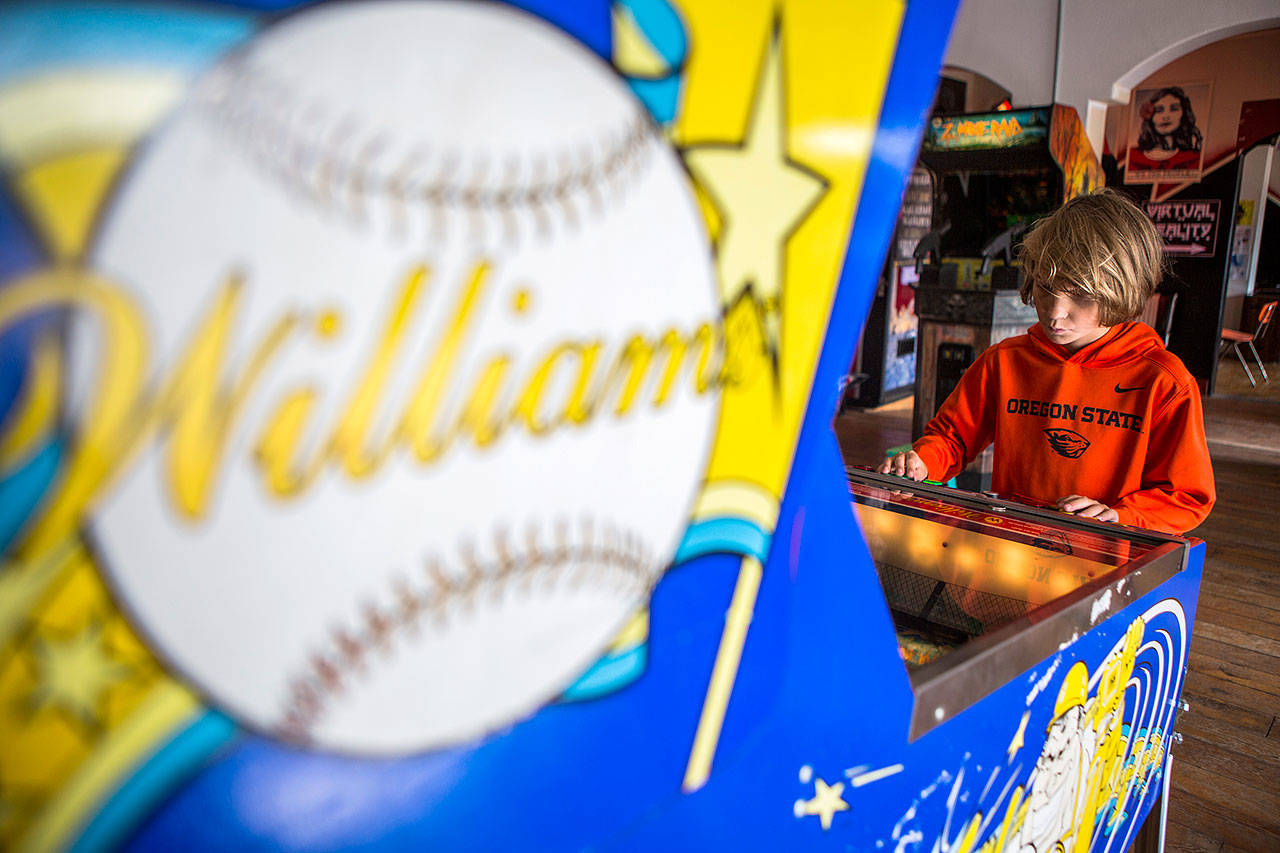 Nathan Weaver plays a baseball pinball game at The Machine Shop in Langley. (Olivia Vanni / The Herald)
