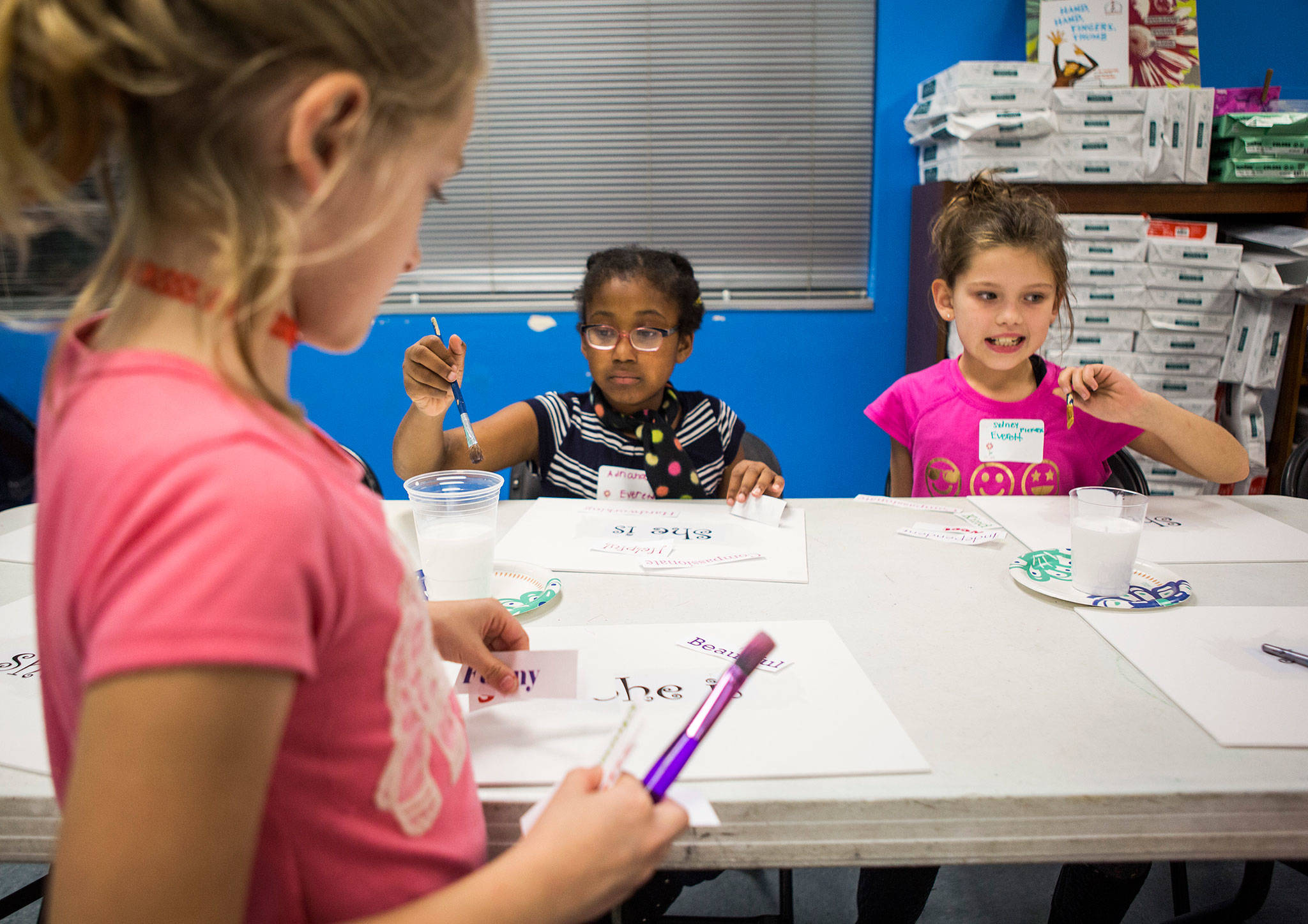 Adriana Smith (center) and Sydney Piekarski (right), both 8, work during an InspireHER event at the Snohomish Boys & Girls Club. (Olivia Vanni / The Herald)