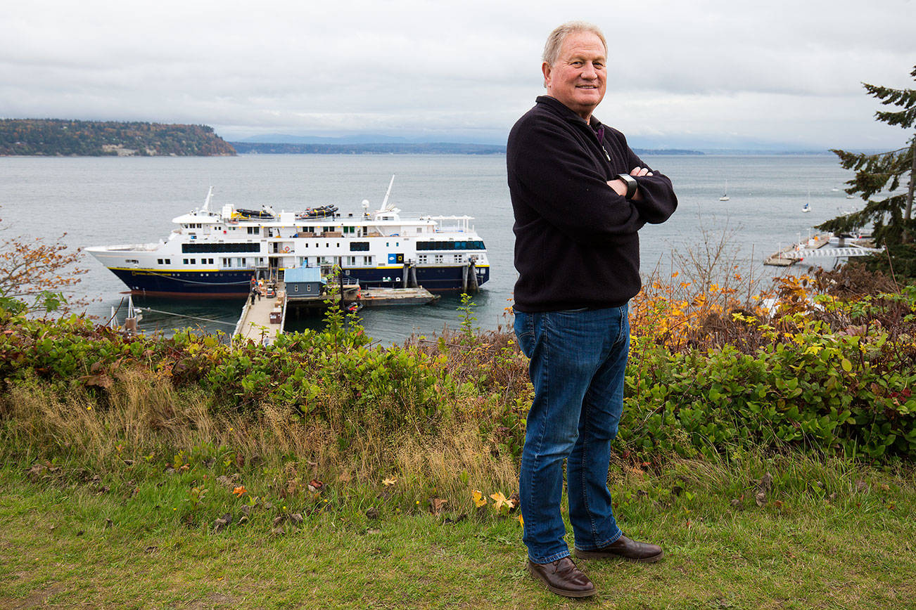 Matt Nichols, president of Nichols Brothers Boat Builders, stands above the National Geographic Venture docked at the company’s private outfitting pier in Langley. The 240-foot cruise ship is the newest custom vessel built at the main Freeland shipyard. (Andy Bronson / The Herald)